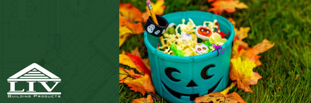 teal halloween bucket sitting in grass